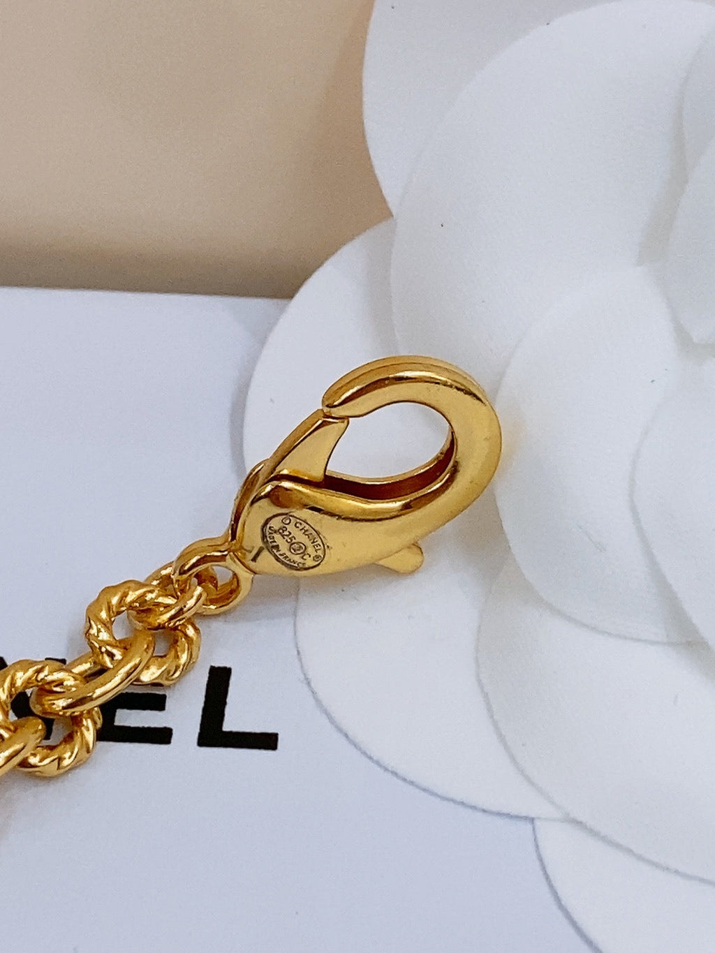 CHANEL TWISTED CHAIN BELT WITH RHINESTONES AND LOGO PLATE IN GOLD TONE
